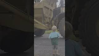 Kid watches huge dump truck drive by [upl. by Atinehc]