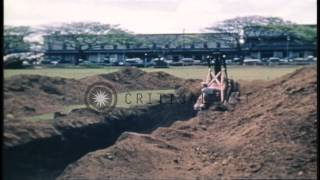 Bulldozer and workers dig air raid shelter trenches in Honolulu Hawaii at start HD Stock Footage [upl. by Ayital]