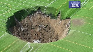 Surveillance video shows moment when 100footwide sinkhole swallows Alton Illinois soccer field [upl. by Tigirb]