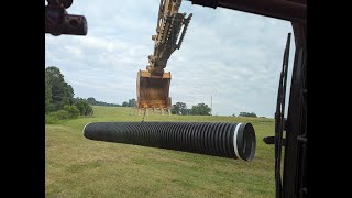 Excavator Installing a 24quot Pipe and Cleaning Another Pipe Entry [upl. by Lennaj239]