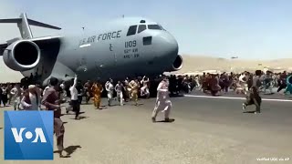 Afghans Try to Flee at Kabul Airport [upl. by Sale]