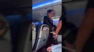 Moment woman shreds flight attendants shirt with her teeth on plane [upl. by Llevra]