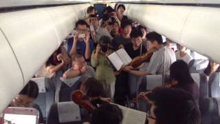 Philadelphia Orchestra musicians perform on flight waiting on Beijing tarmac [upl. by Odnanreh]