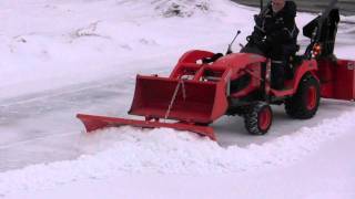 Snow blower plow and bucket on Kubota BX clearing hard snow [upl. by Brom]